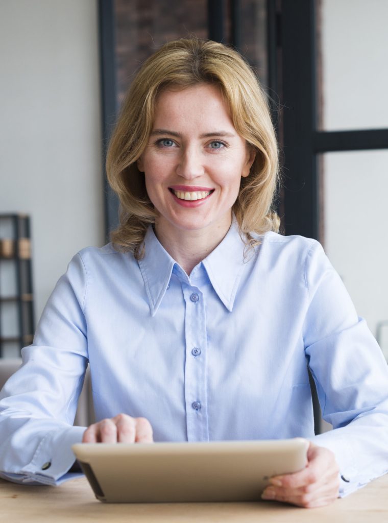 joyful-business-woman-using-tablet-table